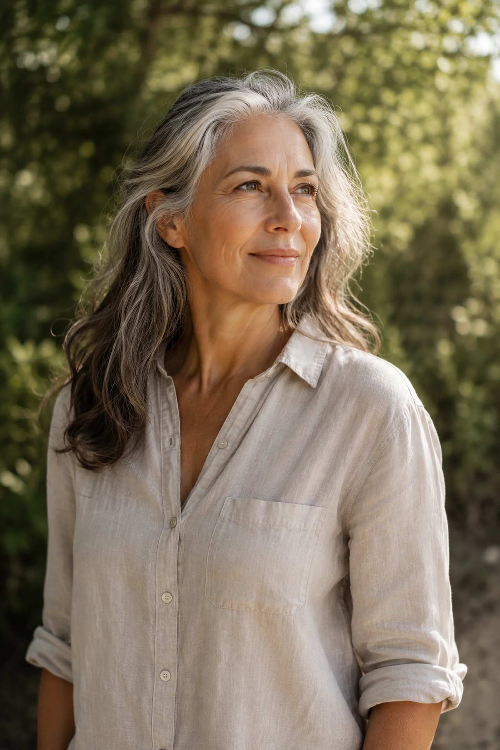 A confident, healthy woman in her fifties smiling outdoors
